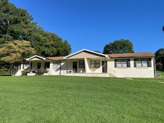This image displays two entrances to brick row houses, this image also shows the front yard